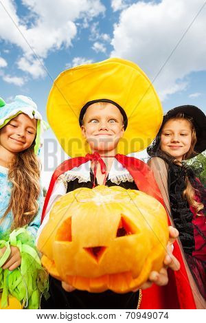 Boy in Halloween costume makes face