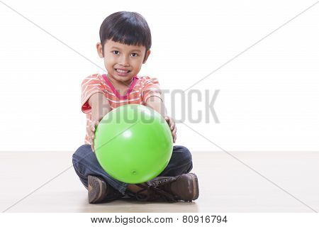 Cute little boy playing green ball
