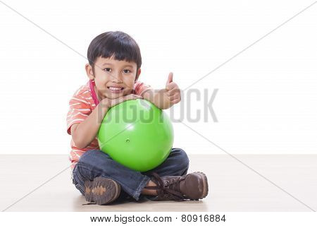 Cute little boy playing green ball