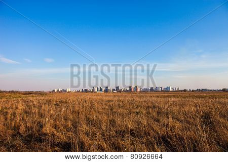 Urban Landscape. Dry Field And Kyiv In The Distance