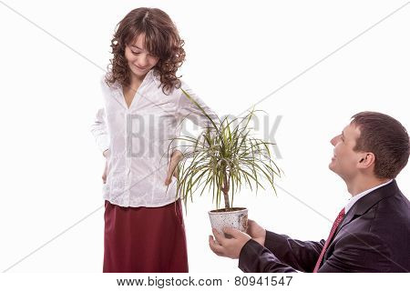 Portrait Of Caucasian Couple Together Having Fun. Allegoric Flower Gift Presentation To Female. Isol