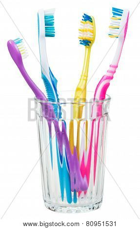 Four Toothbrushes In Glass