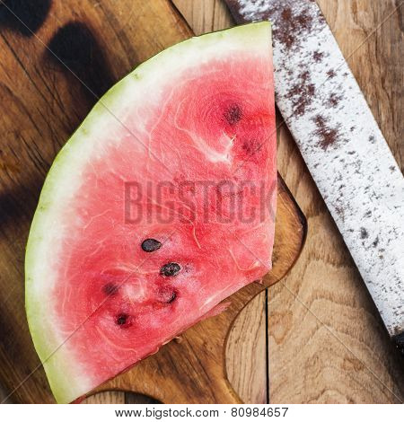 watermelon and old knife on the table