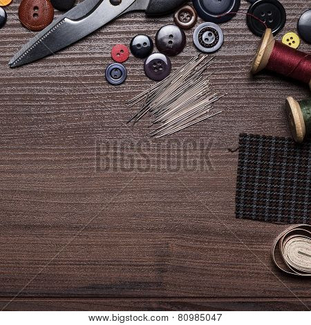 needles threads and buttons on the table