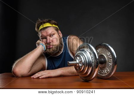 Sad man with a dumbbell