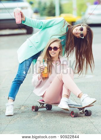 Hipster girlfriends taking a selfie in urban city context - Concept of friendship and fun with new t