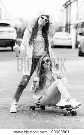 Hipster girlfriends taking a selfie in urban city context - Concept of friendship and fun with new t