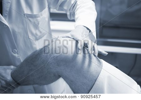 Traumatologist Orthopedic Surgeon Doctor Examining Patient