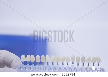Dental Nurse Holding Implant And Crown Tooth Color Guide