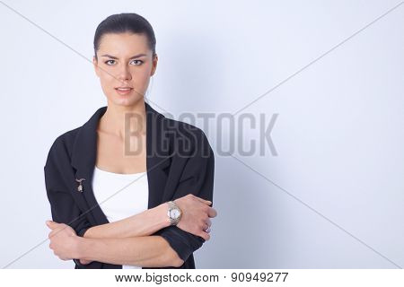 A young woman standing, isolated on graybackground