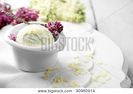 Beautiful composition with tasty ice cream and lilac flowers