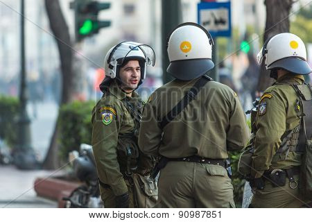 ATHENS, GREECE - CIRCA APR, 2015: Riot police with their shield, take cover during a rally in front of Athens University, which is under occupation by protesters leftist and anarchist groups.