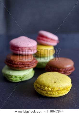 Colorful Macaroons Variety Closeup On Dark Background. A French Sweet Delicacy. Dessert