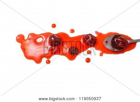 splashes and spilled strawberry jam with a spoon
