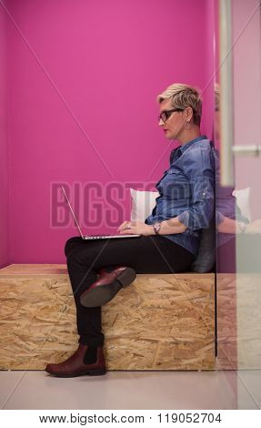 young woman in crative box working on laptop computer, startup business modern office room  interior