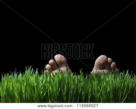 Feet Of A Person Laying In Green Grass At Night