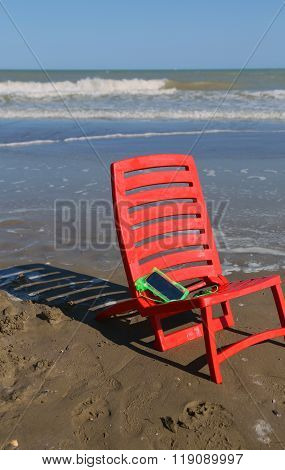 Chair On The Beach By The Ocean Wave