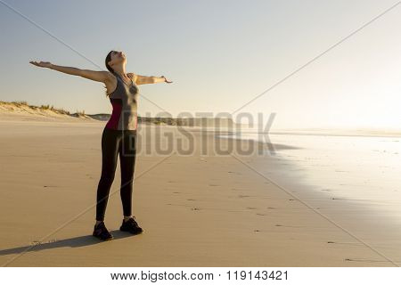 Beautiful woman open her arms and relaxing after her exsercise