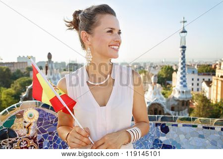Smiling Woman Tourist With Spain Flag In Park Guell, Barcelona