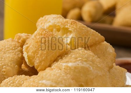 Pastel, A Brazilian Snack, With A Bar In The Background. Cheese Pastry.