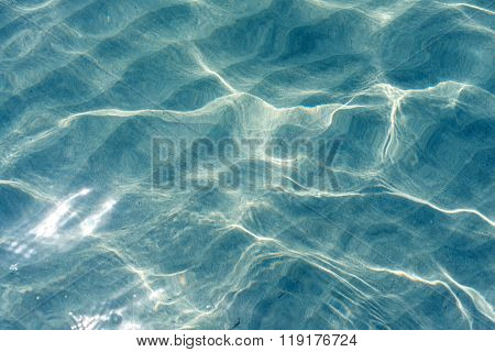 Transparent clear water with sunlight reflection