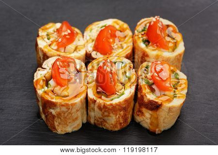Fusion Rolls With Omelette And Tomatoes On Black Palte