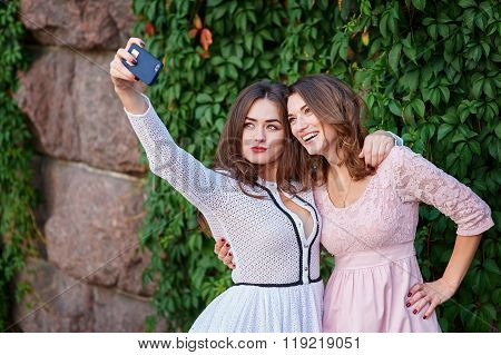 Two beautiful women doing Selfe