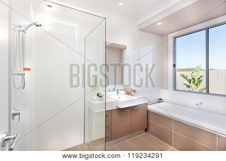 Modern Bathroom With A Faucet, Water Tub And A Dark Brown Floor Tile