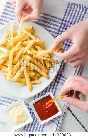 Hands Picking French Fries