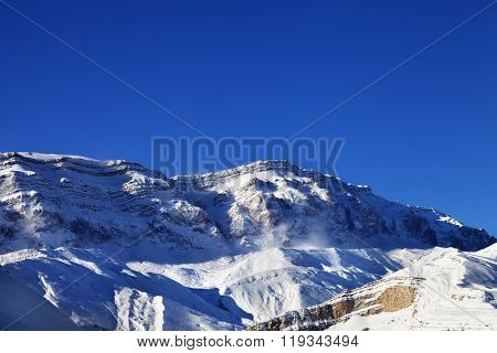 Snowy Mountains At Sun Windy Day