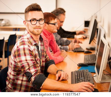 Group Of Adults Learning Computer Skills. Intergenerational Transfer Of Knowledge.