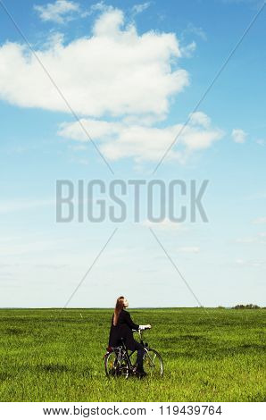 Happy Young Woman With A Vintage Bicycle On A Green Meadow. Youn