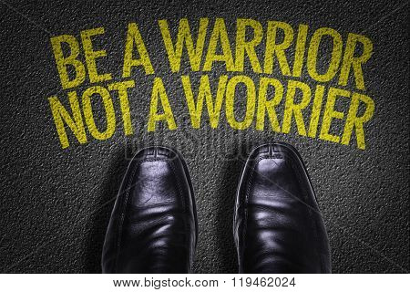 Top View of Business Shoes on the floor with the text: Be a Warrior Not a Worrier