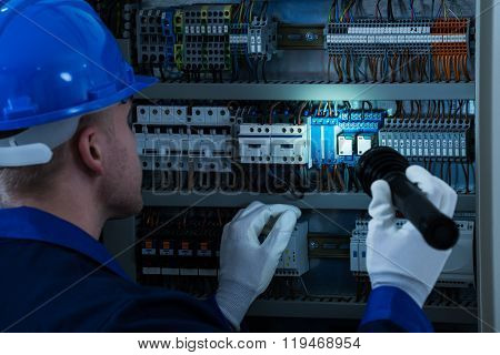 Male Technician Testing Fusebox