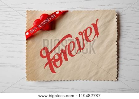 Blank present Valentine card on wooden background