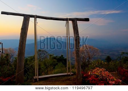 wooden swing center natral location and blue sky color