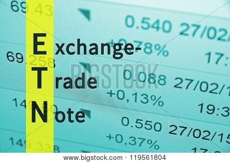 Acronym ETN as Exchange-traded note. Financial data on the background.