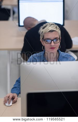 startup business, woman  working on dektop  computer at creative modern office relaxing and have fun