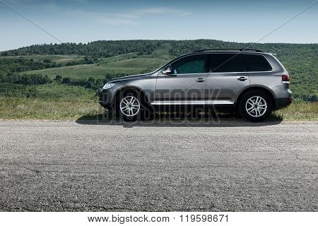 Saratov, Russia - May 18, 2014: Premium Car Volkswagen Touareg Stay On Asphalt Road Near Mountain At