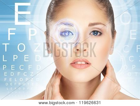 Beautiful woman with laser hologram and test vision table over cyan background.