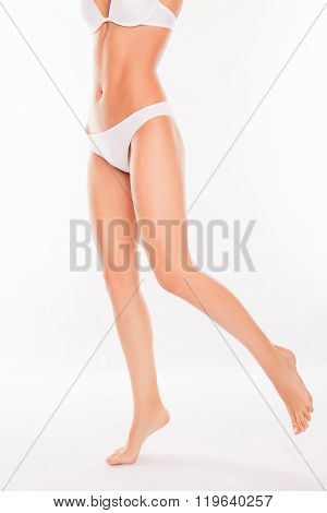 Close Up Portrait Of Fit Slim Woman's Body On White Background