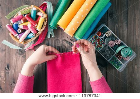 Top View Of Woman Hands Sewing Pink Hamdmade Toy
