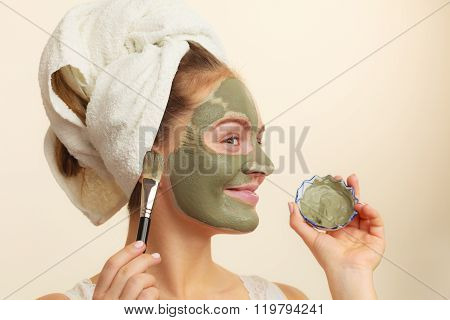 Woman Applying With Brush Clay Mud Mask To Her Face