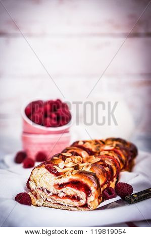 Raspberry Cake With Almonds On Wooden Background