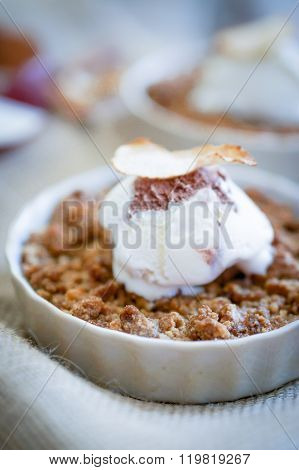 Apple Crumble Dessert With Cinnamon And Vanilla Ice Cream On Wooden Background