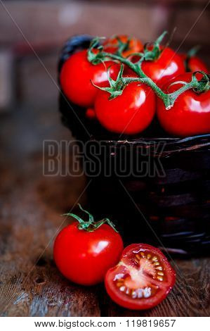 Tomatoes In The Basket On Wooden Background