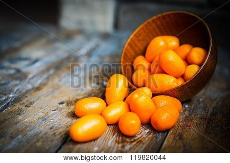 Kumquat In A Bowl On Rustic Wooden Table