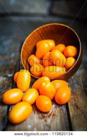 Kumquat In A Bowl On Rustic Wooden Table