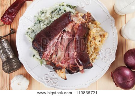 Roasted pork knuckle with mashed potato and sour cabbage or sauerkraut