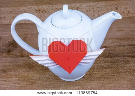White teapot with red heart. Love tea.